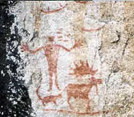 Pictograph on Hegman Lake showing a human figure in an outstretched arms posture standing near a quadruped animal with a long tail and a  bull moose with splayed hooves and dew claws.